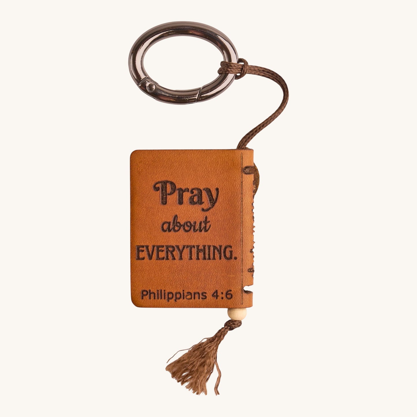 Holy Matters vegetable-tanned leather mini Bible keepsake keychain with Philippians 4:6 scripture engraving.