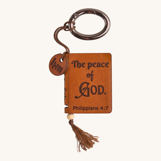 Holy Matters vegetable-tanned leather mini Bible keepsake keychain with Philippians 4:7 scripture engraving