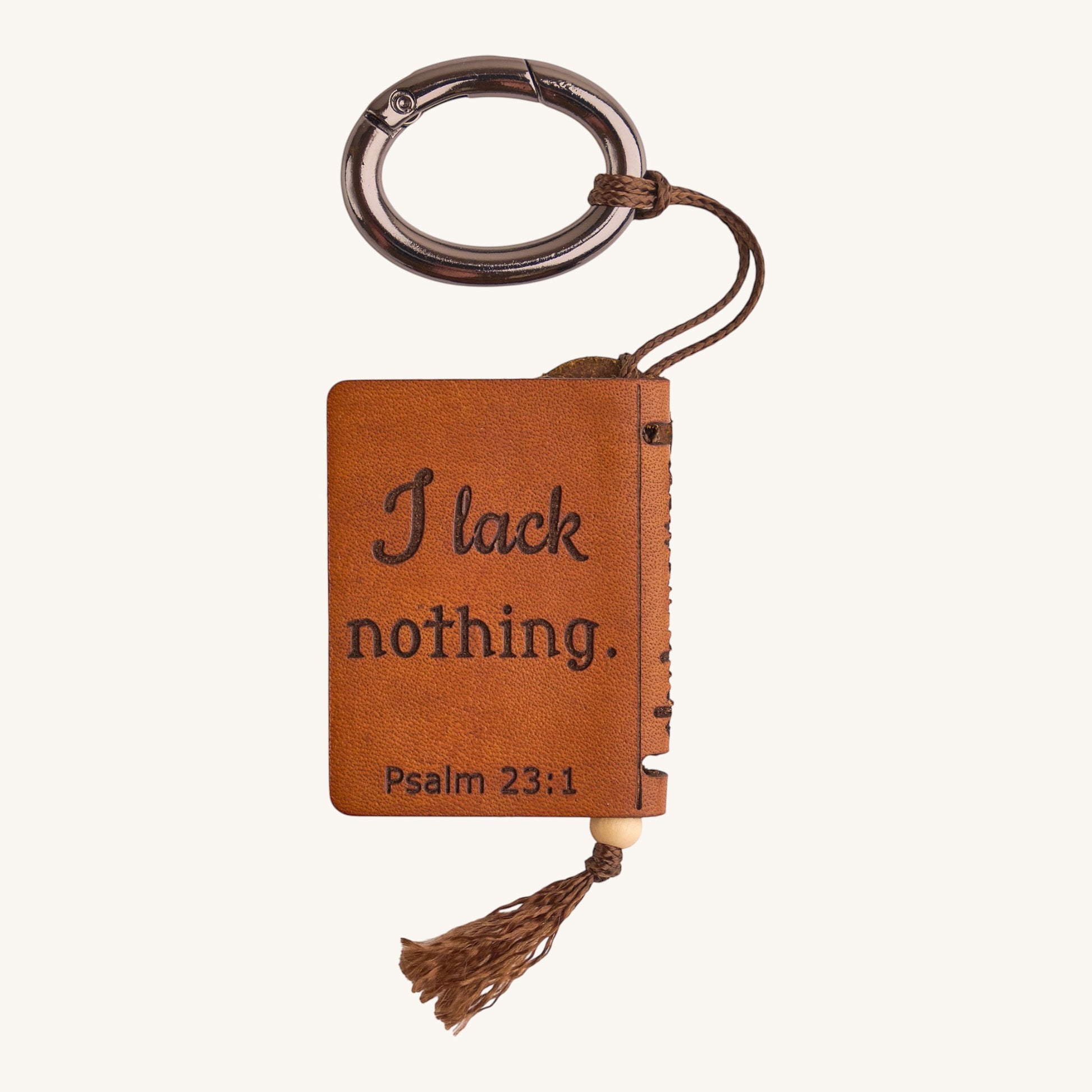 Holy Matters vegetable-tanned leather mini Bible keepsake keychain featuring Psalm 23:1 engraving and a tassel charm.