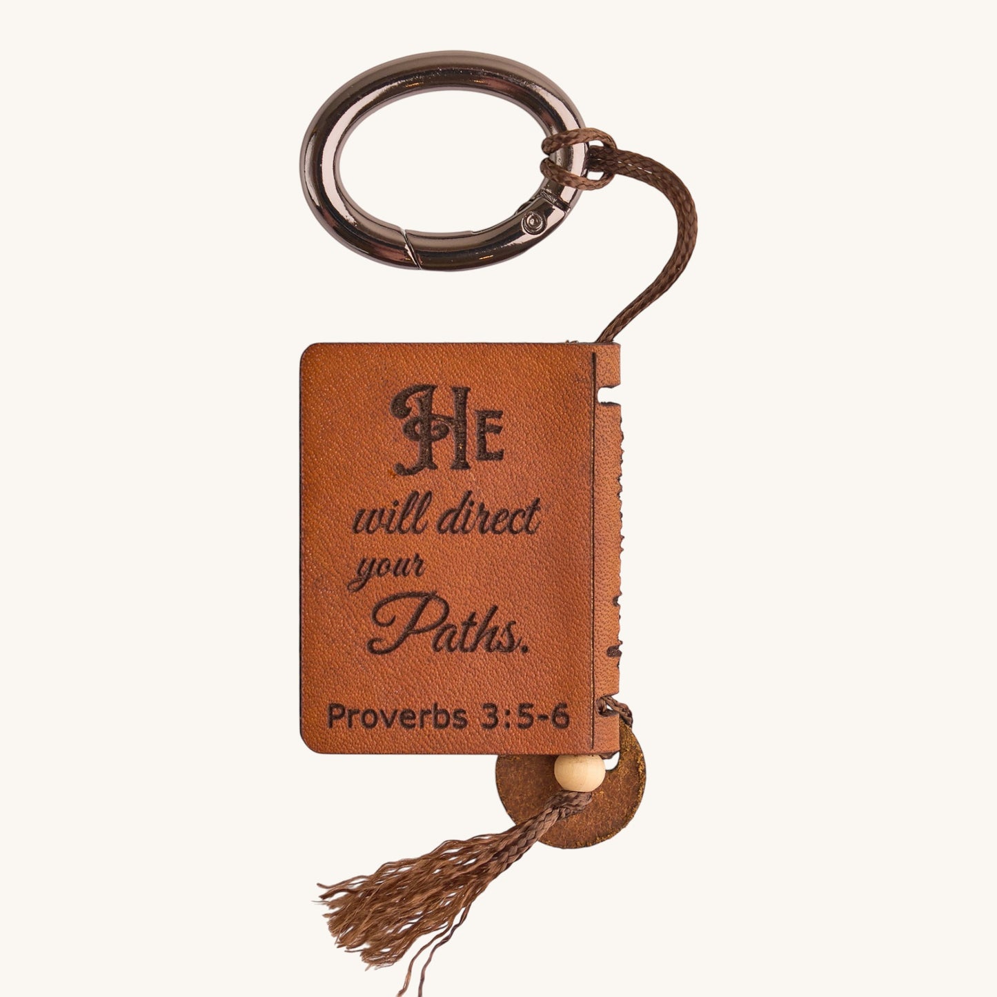 Holy Matters vegetable-tanned leather mini Bible keepsake with Proverbs 3:5-6 engraving and brown tassel keychain.