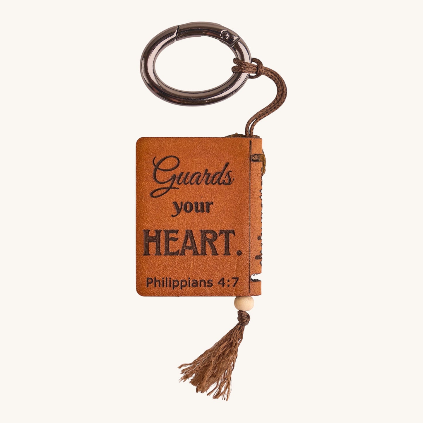 Holy Matters vegetable-tanned leather mini Bible keepsake with Philippians 4:7 engraving and brown tassel keychain