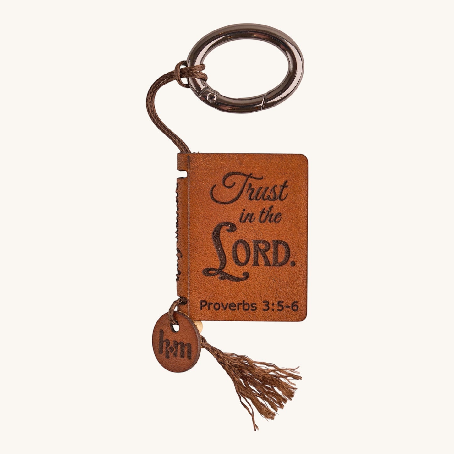 Holy Matters vegetable-tanned leather mini Bible keepsake with Proverbs 3:5-6 engraving, tassel, and metal keyring.