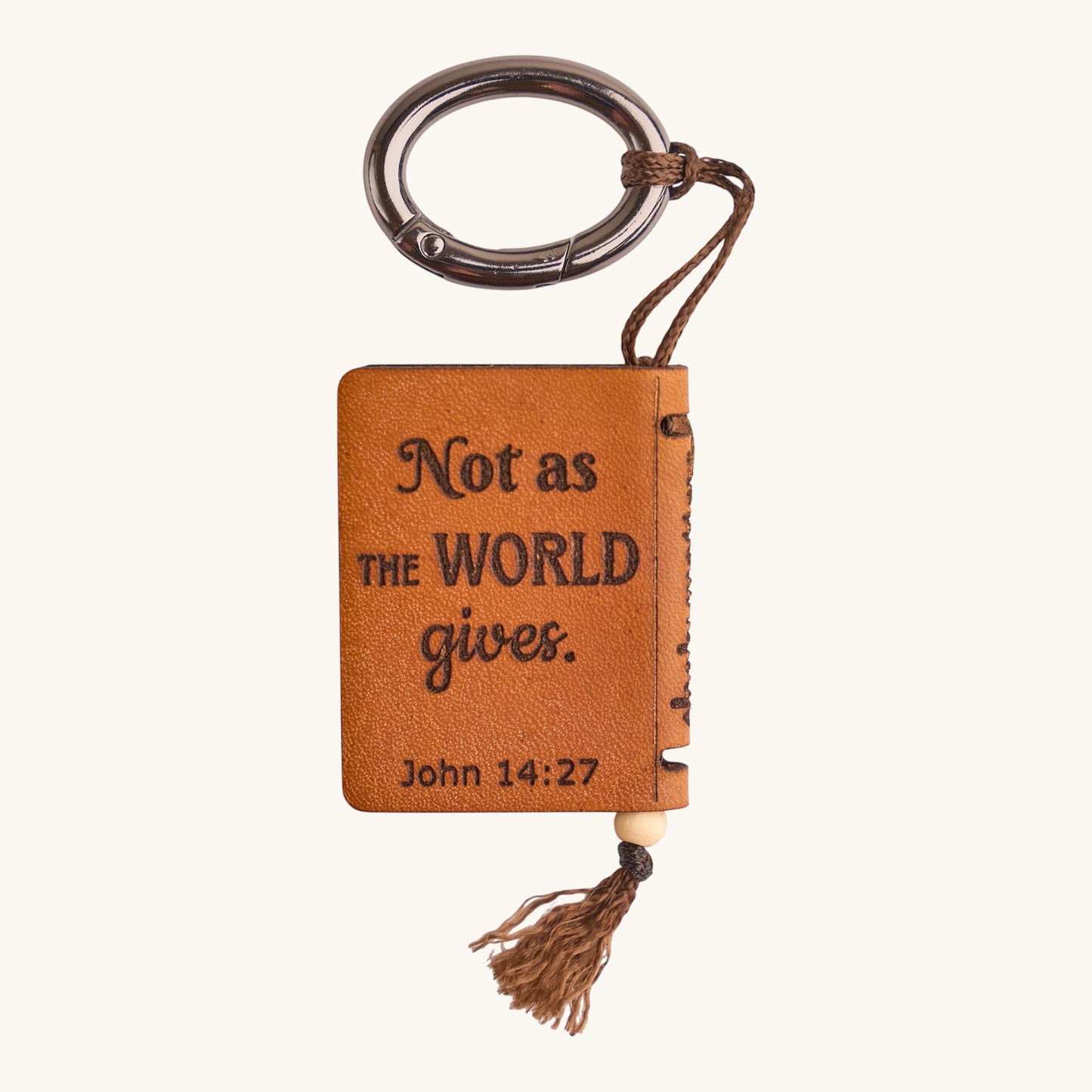 Holy Matters handcrafted tan vegetable-tanned leather mini Bible keepsake with John 14:27 scripture and metal keyring.