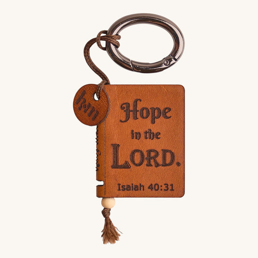 Holy Matters handcrafted vegetable-tanned leather mini Bible keepsake keychain with Isaiah 40:31 scripture engraving