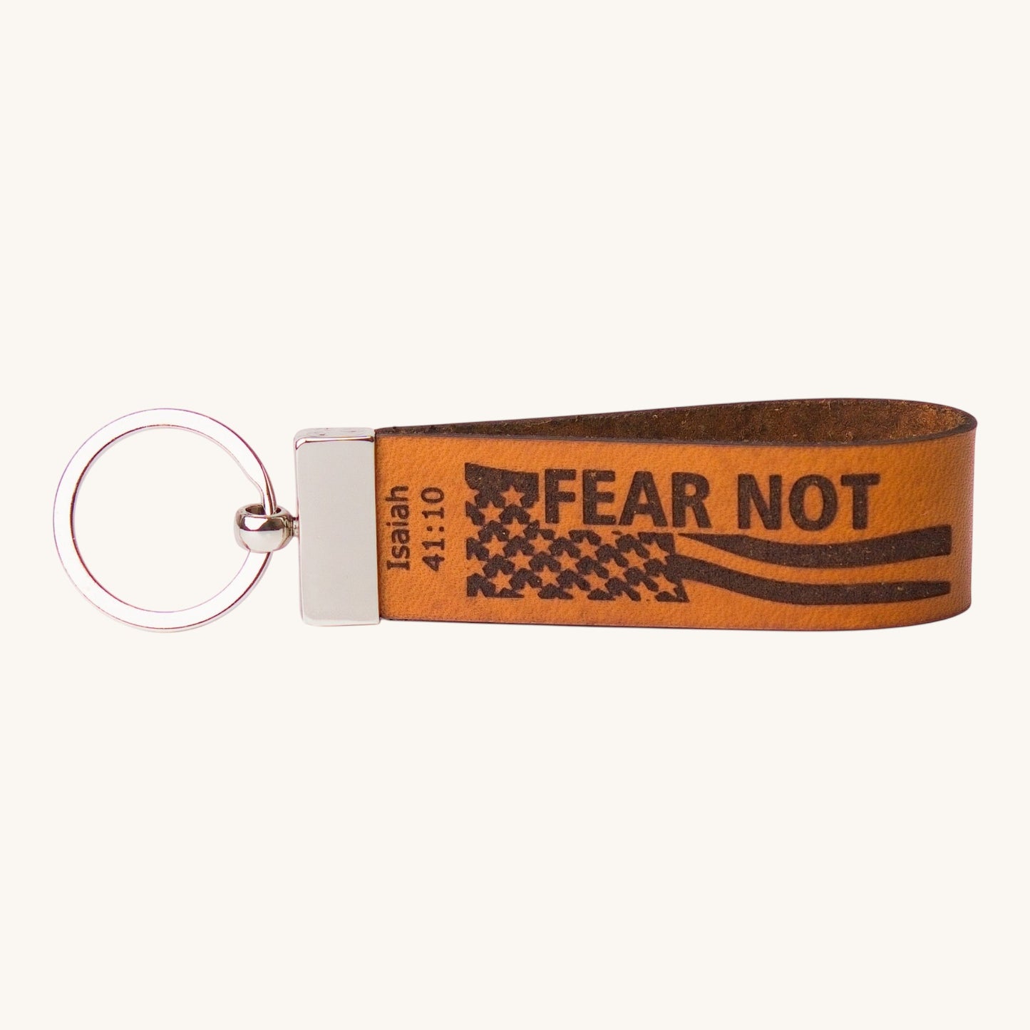 Holy Matters handcrafted vegetable-tanned leather keychain featuring Isaiah 41:10 Fear Not scripture and flag design.