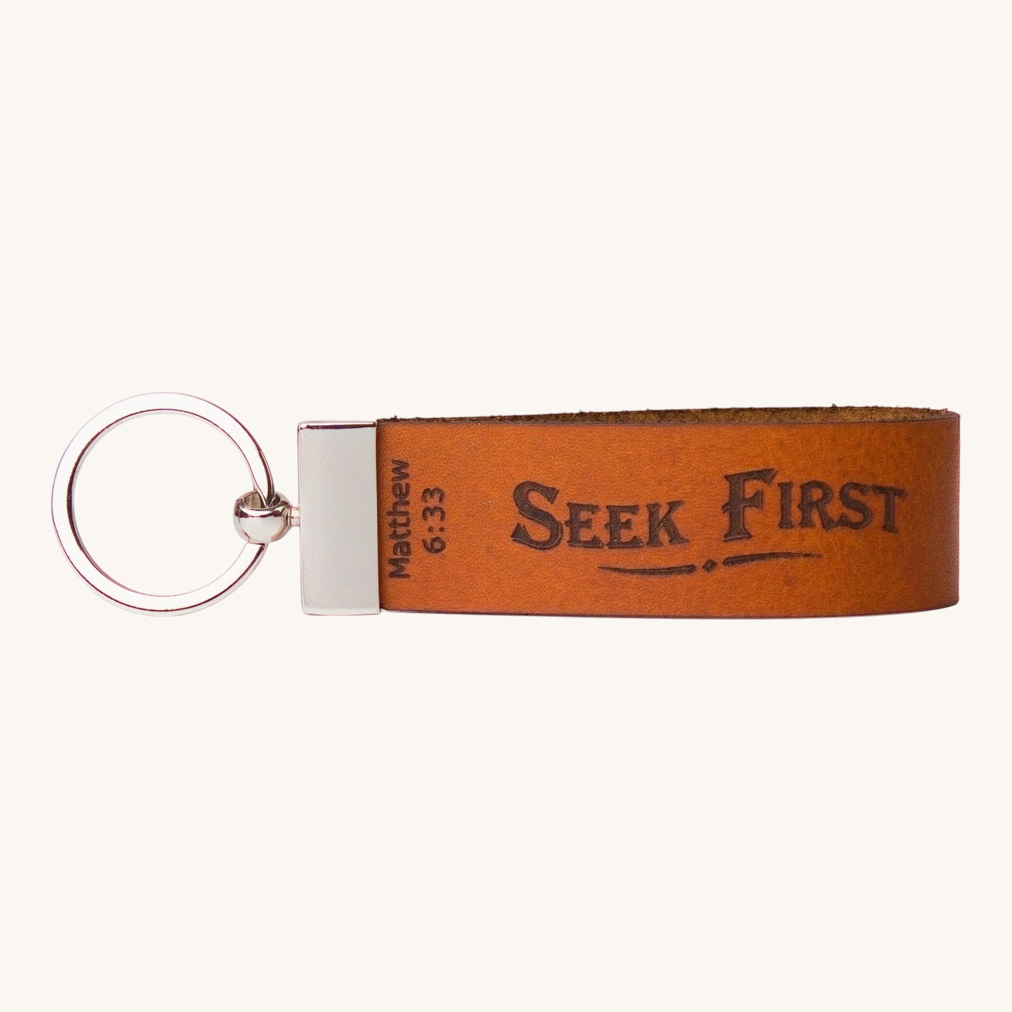 Holy Matters tan vegetable-tanned leather keychain embossed with Seek First Matthew 6:33 scripture