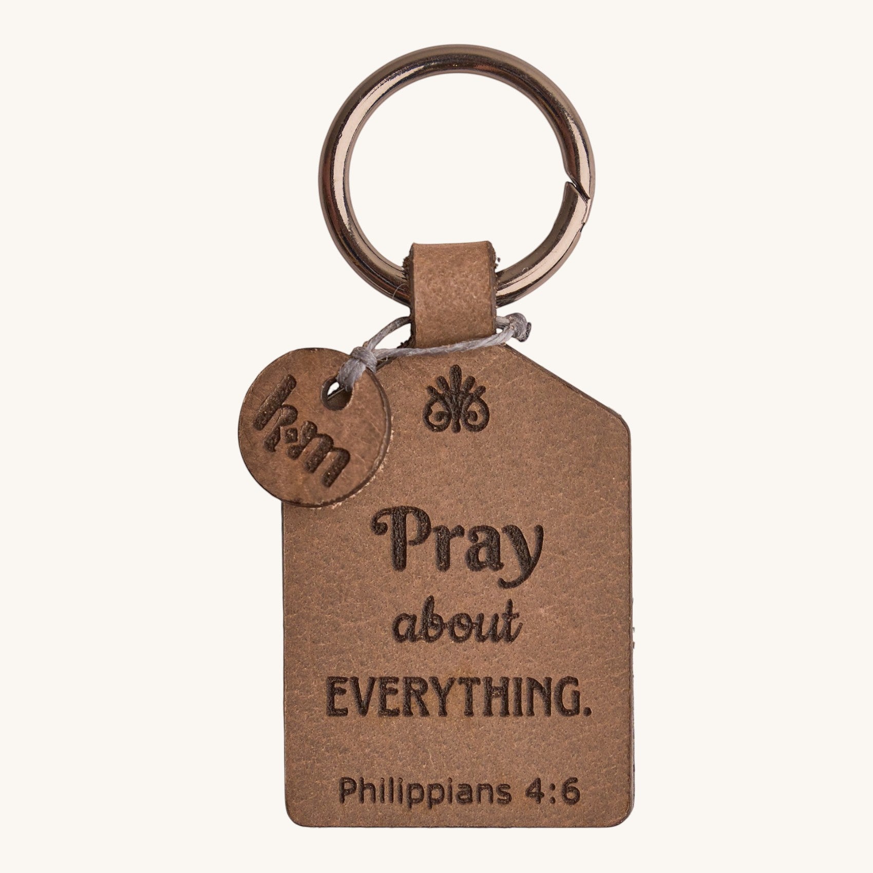 Holy Matters vegetable-tanned leather keychain tag engraved with Pray about everything and Philippians 4:6 verse