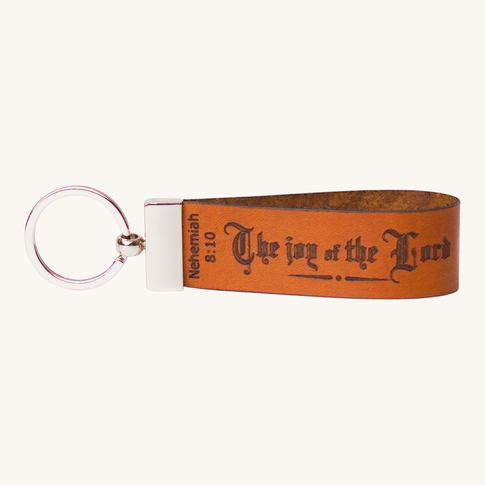 Holy Matters handcrafted vegetable-tanned leather keychain embossed with Nehemiah 8:10 scripture in black lettering