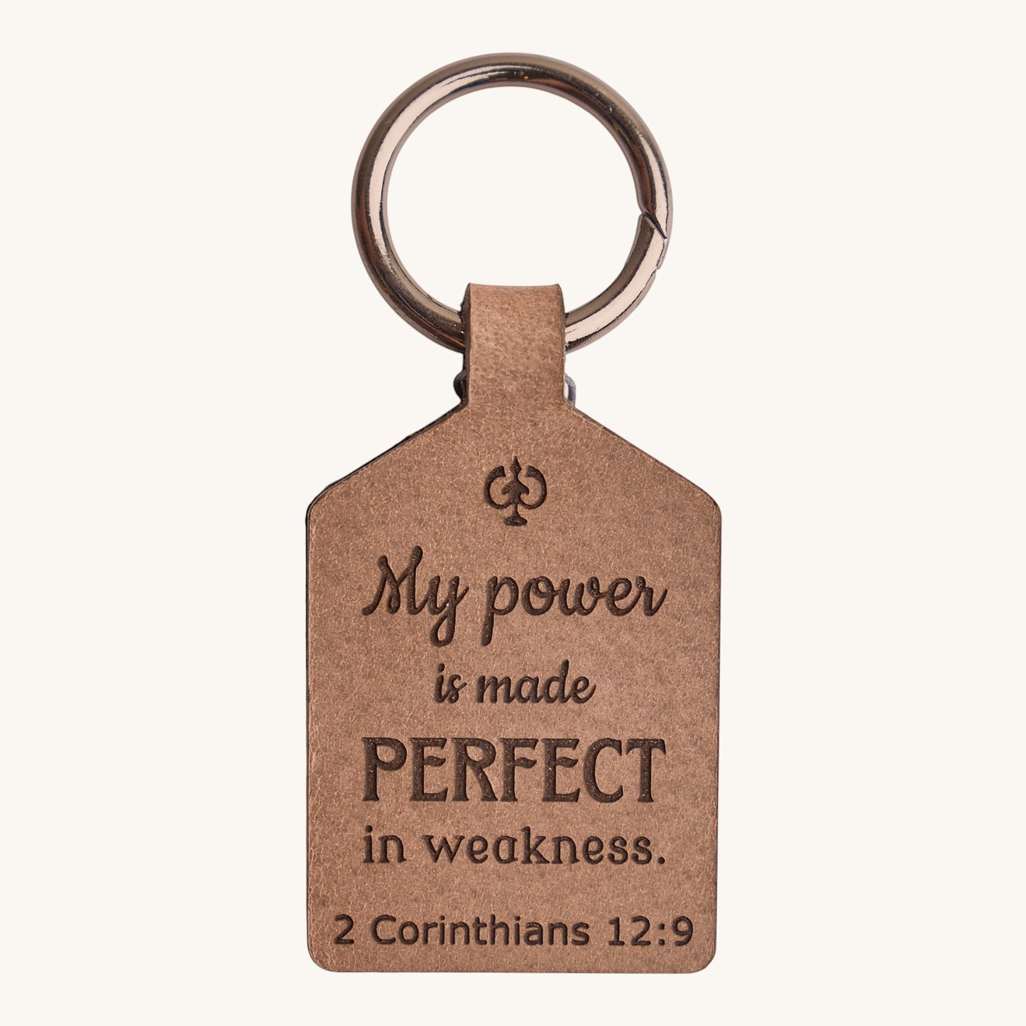 Holy Matters handcrafted vegetable-tanned leather keychain engraved with 2 Corinthians 12:9 scripture verse