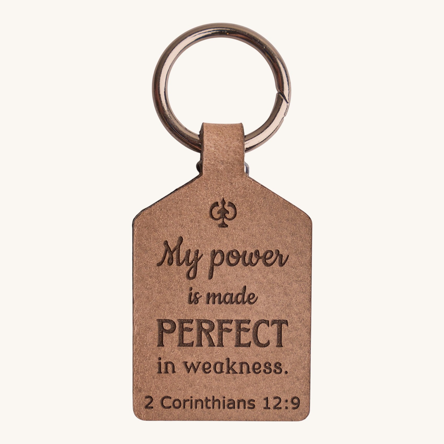 Holy Matters handcrafted vegetable-tanned leather keychain engraved with 2 Corinthians 12:9 scripture verse