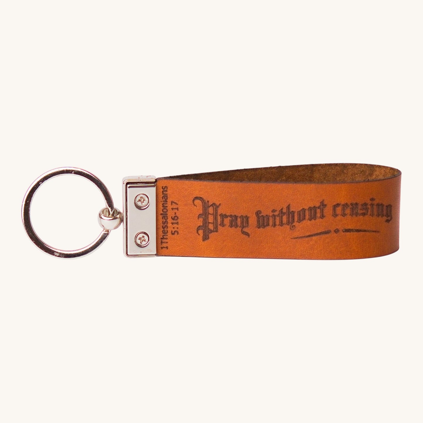 Holy Matters handcrafted tan vegetable-tanned leather keychain with Pray without ceasing scripture engraving