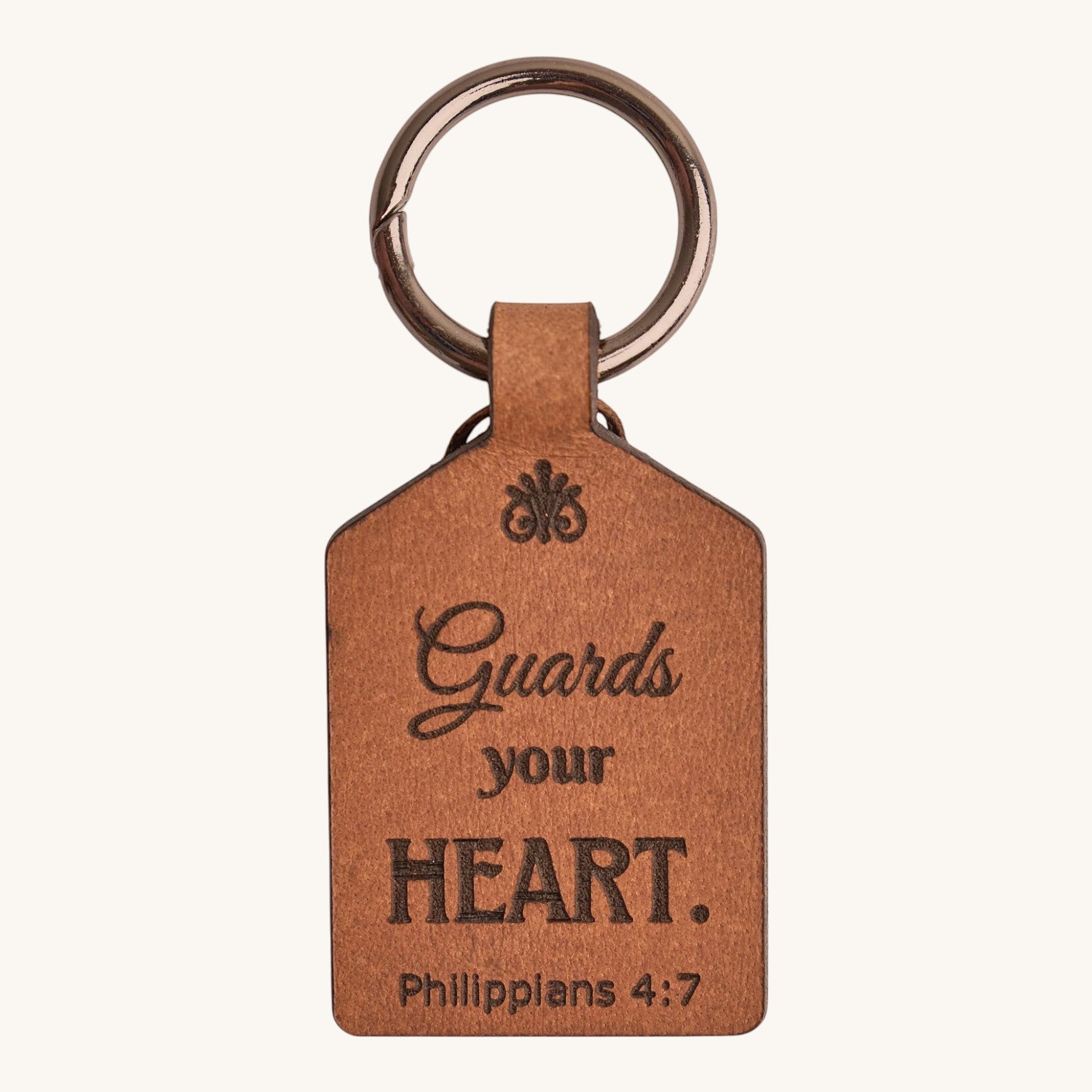 Holy Matters vegetable-tanned leather keychain engraved with Philippians 4:7 Guards your heart scripture