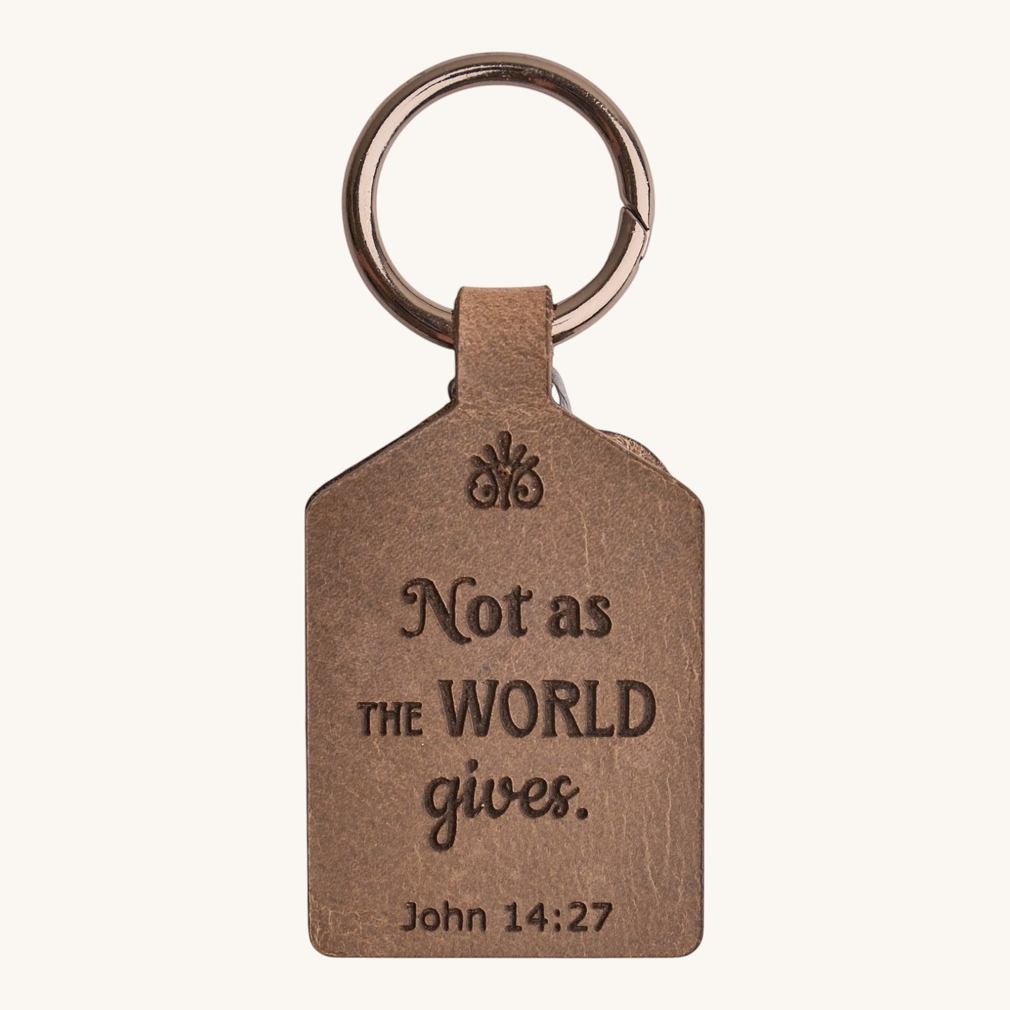 Holy Matters handcrafted vegetable-tanned leather keychain engraved with John 14:27 scripture in a brown finish.