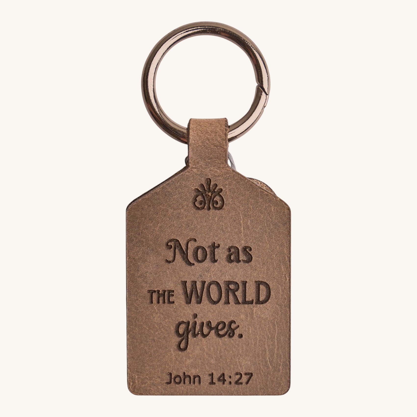 Holy Matters handcrafted vegetable-tanned leather keychain engraved with John 14:27 scripture in a brown finish.