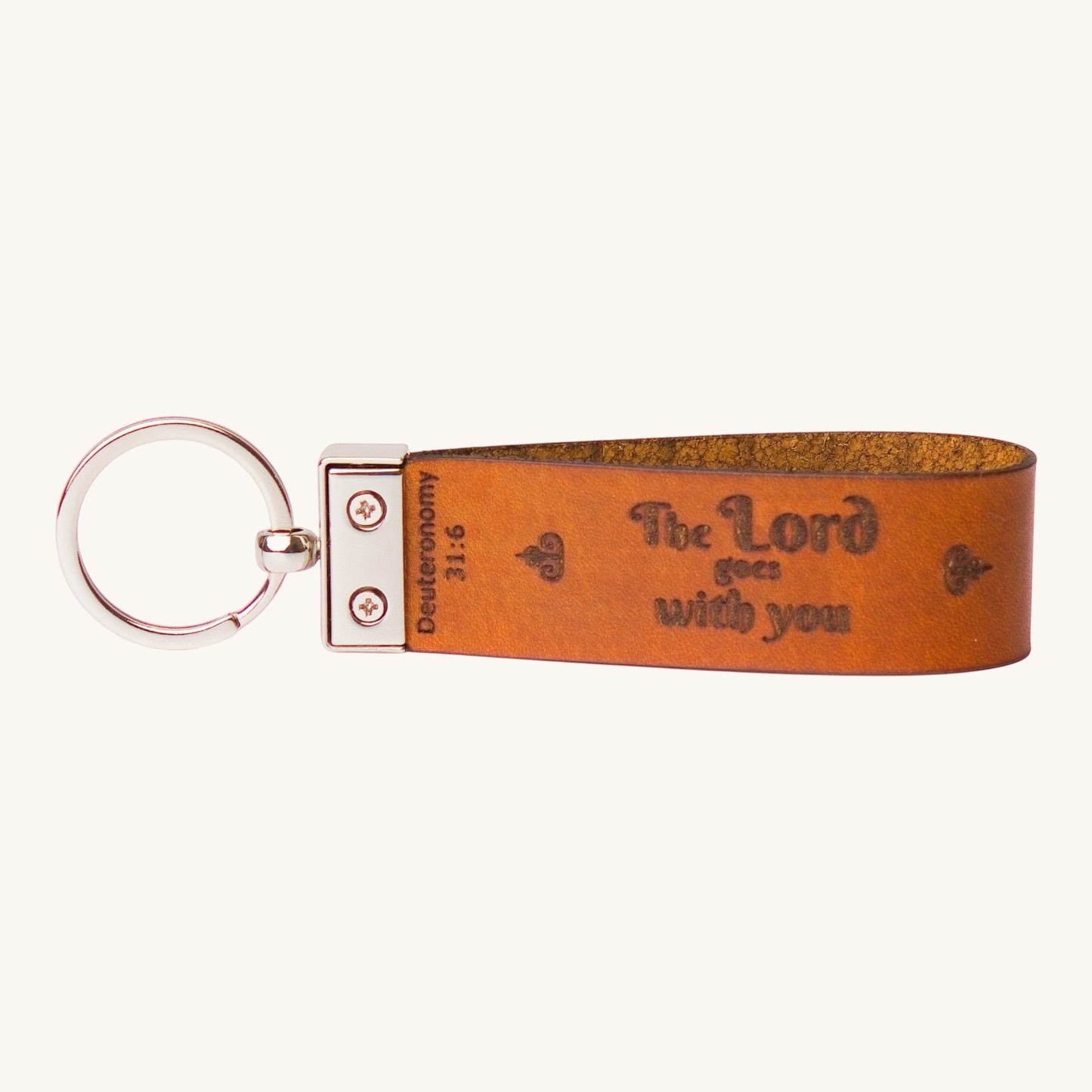 Holy Matters vegetable-tanned leather keychain embossed with Deuteronomy 31:6 scripture and a silver metal ring.