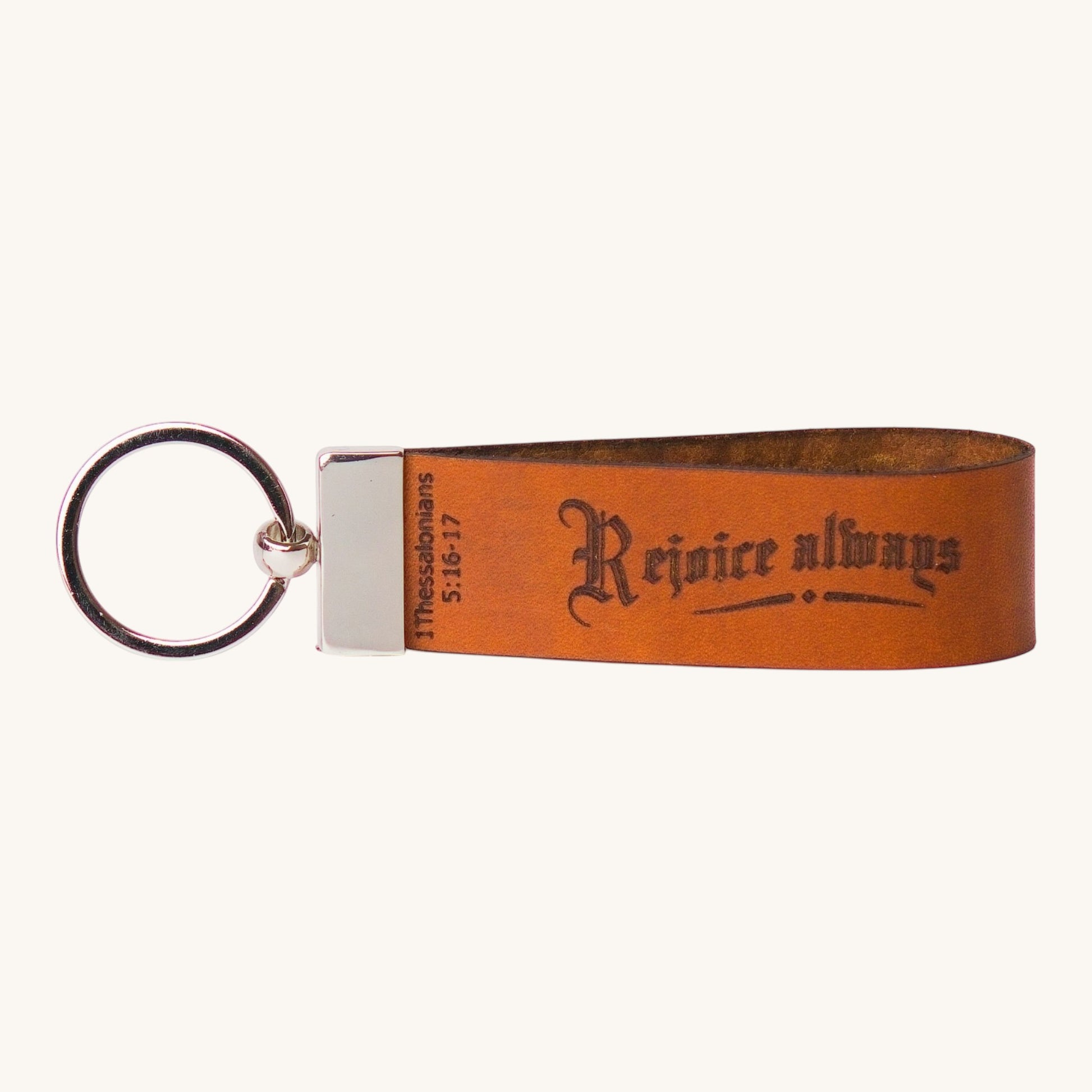 Holy Matters handcrafted vegetable-tanned leather keychain featuring Rejoice always and 1 Thessalonians 5:16-17 text.