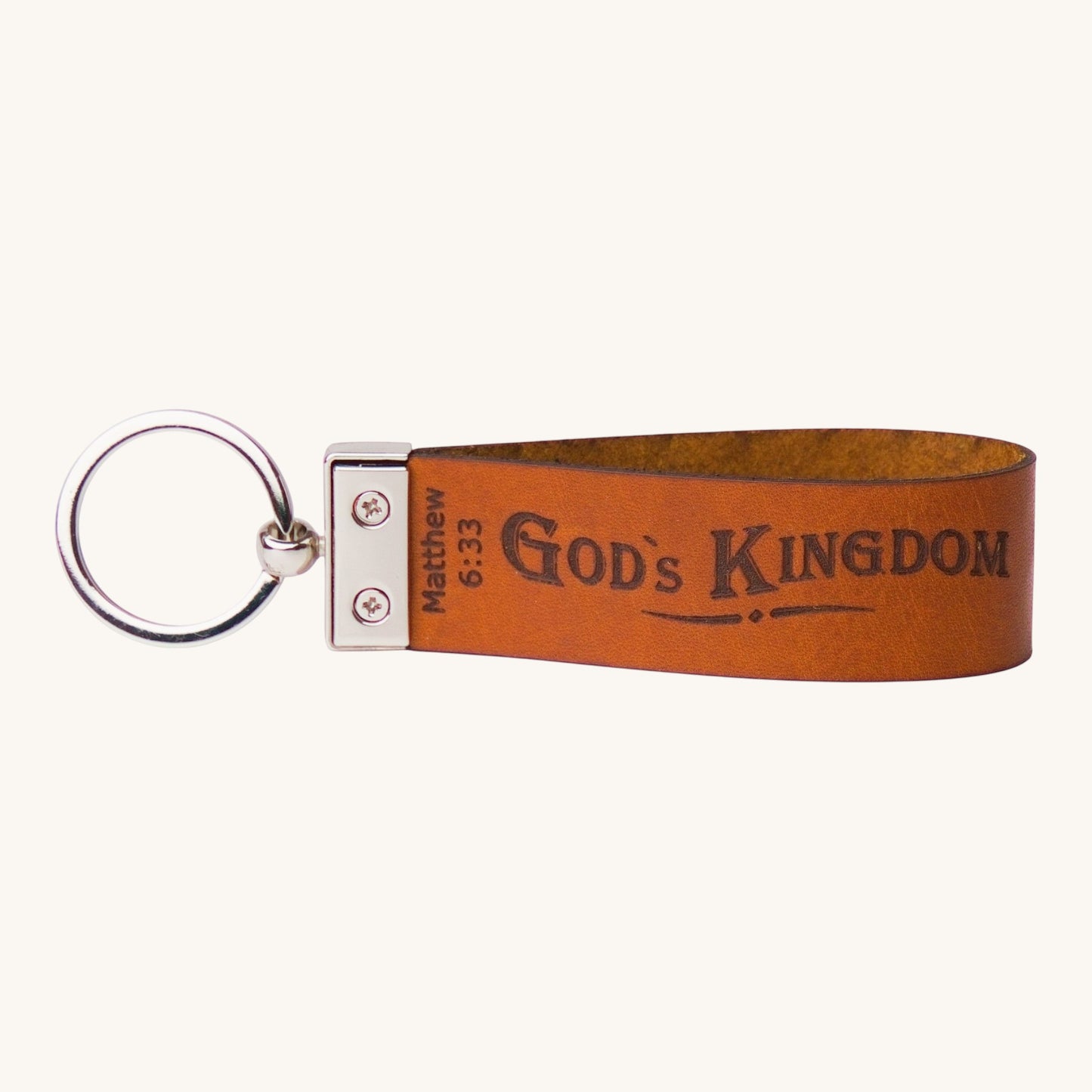 Holy Matters handcrafted tan vegetable-tanned leather keychain embossed with Matthew 6:33 God's Kingdom scripture.